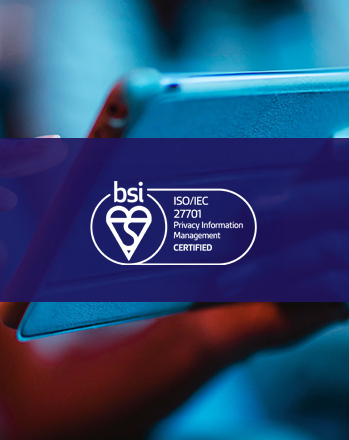 BSI ISO/IEC 27001 Privacy Information Management certified badge over a person holding a tablet.
