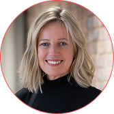 Portrait of a smiling blonde woman wearing a black turtleneck, in a circular red-framed image with a blurred background.